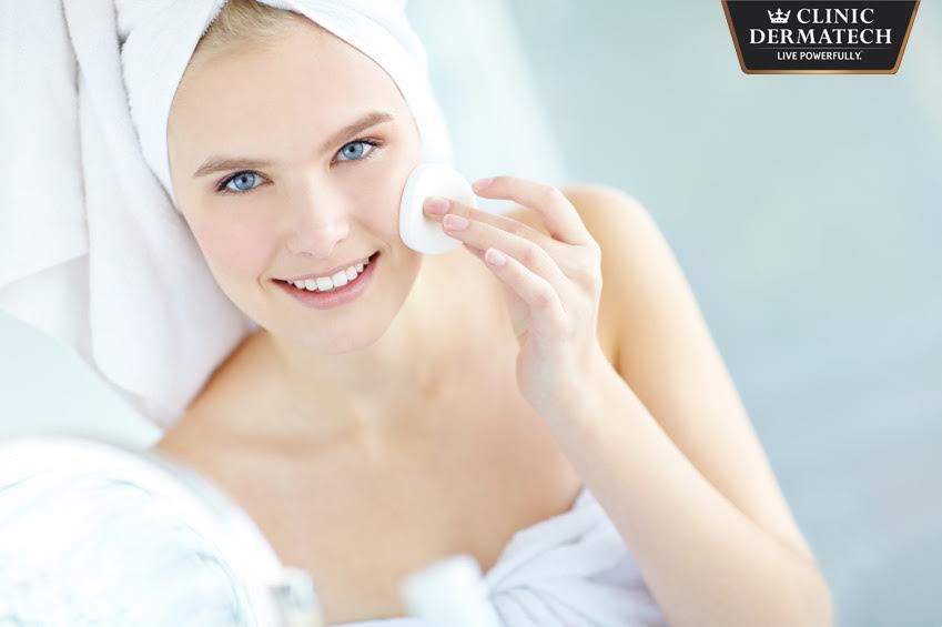 Portrait of a beautiful woman cleaning her face with copyspace